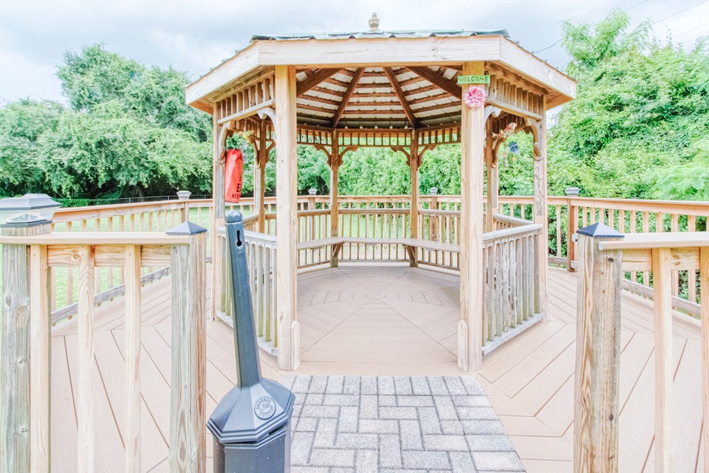 Gazebo with seating surrounded by trees
