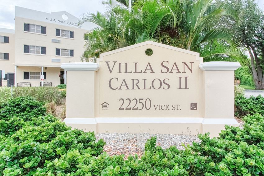 Signage in front of Villa San Carlos Senior Apartments in Port Charolette - Photo Gallery 1