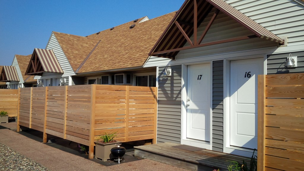a row of houses with a wooden fence in front of them