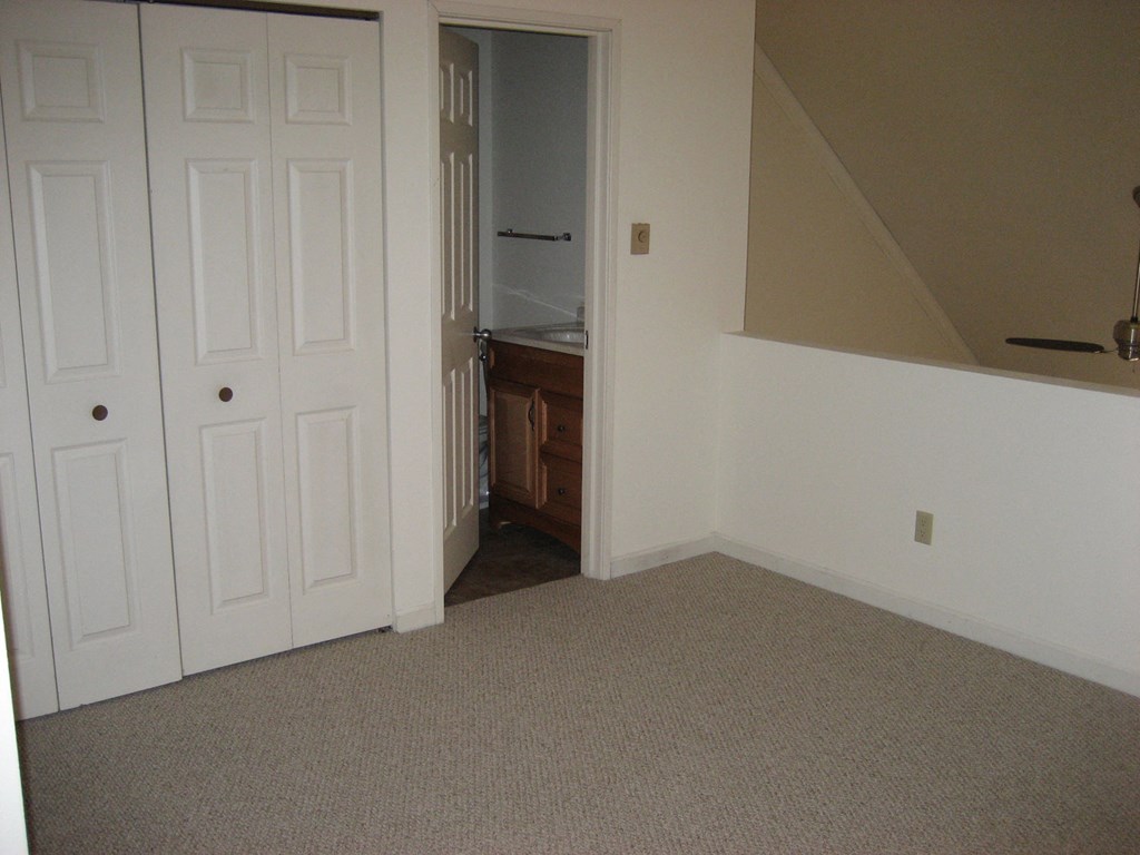 a room with two closets and a door to a bathroom