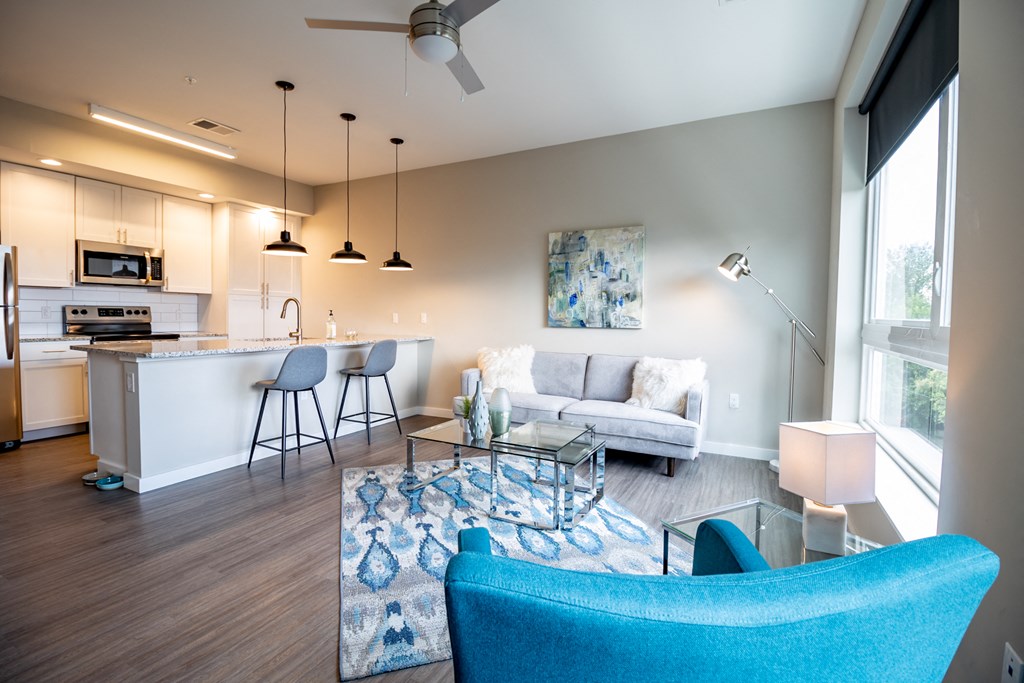 a living room with a kitchen and a couch and a table