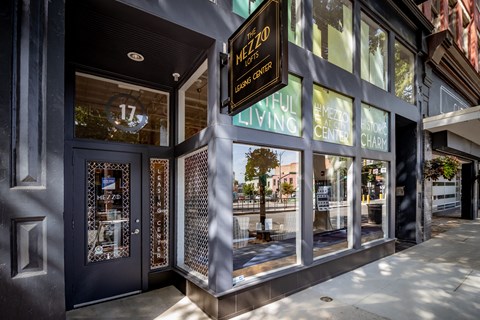 the facade of a building with glass windows and a sign for the living cafe