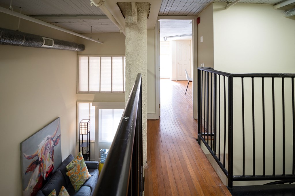 a view of a living room from the top of a staircase