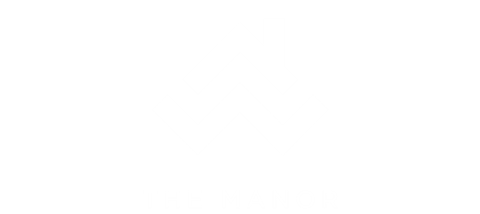 A black and white logo with the text "THE MANOR" below it.