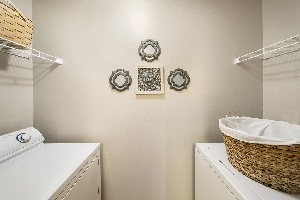 a washer and dryer in a laundry room with a basket