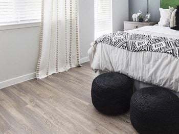 Hardwood-inspired flooring in model bedroom