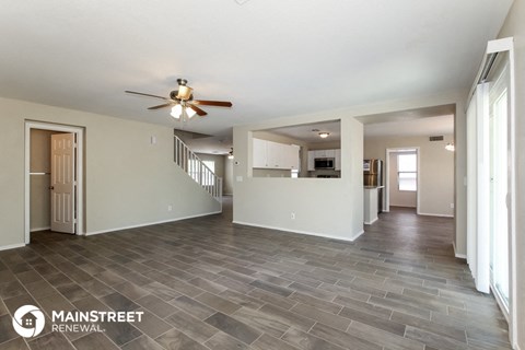 the living room is open to the dining room and kitchen