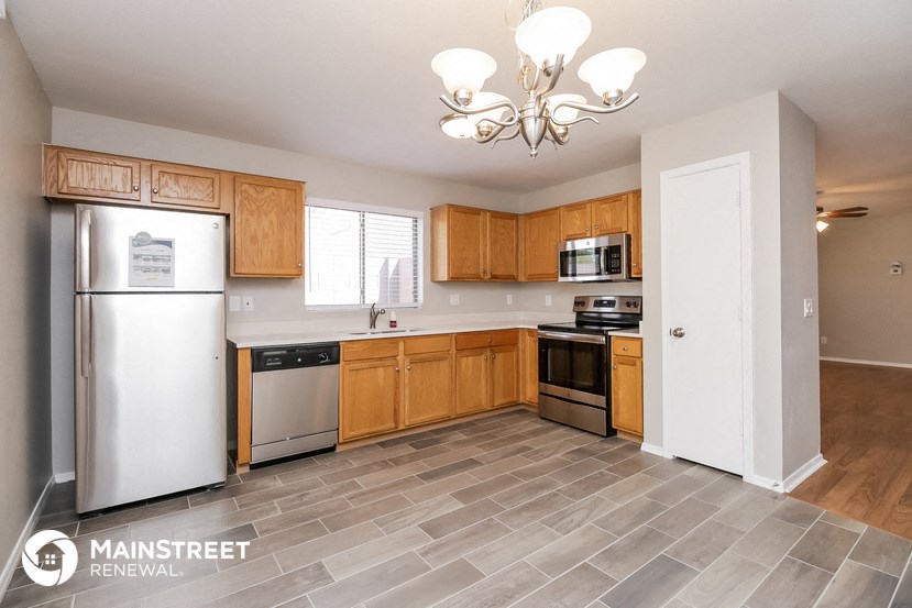 a kitchen with wooden cabinets and stainless steel appliances