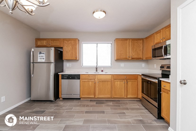 a kitchen with wooden cabinets and stainless steel appliances