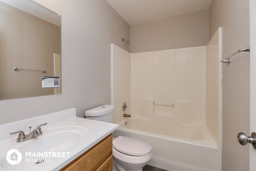 a bathroom with a tub and a sink and a toilet