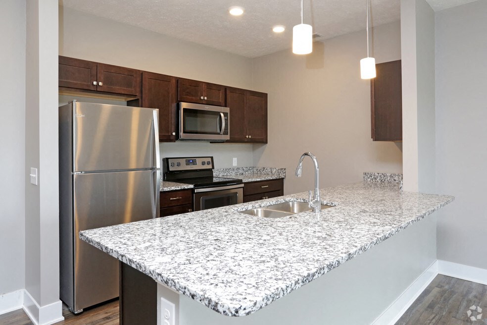 a kitchen with granite counter tops and stainless steel appliances