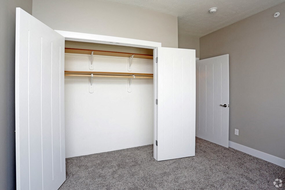 an empty closet in a home with a door open