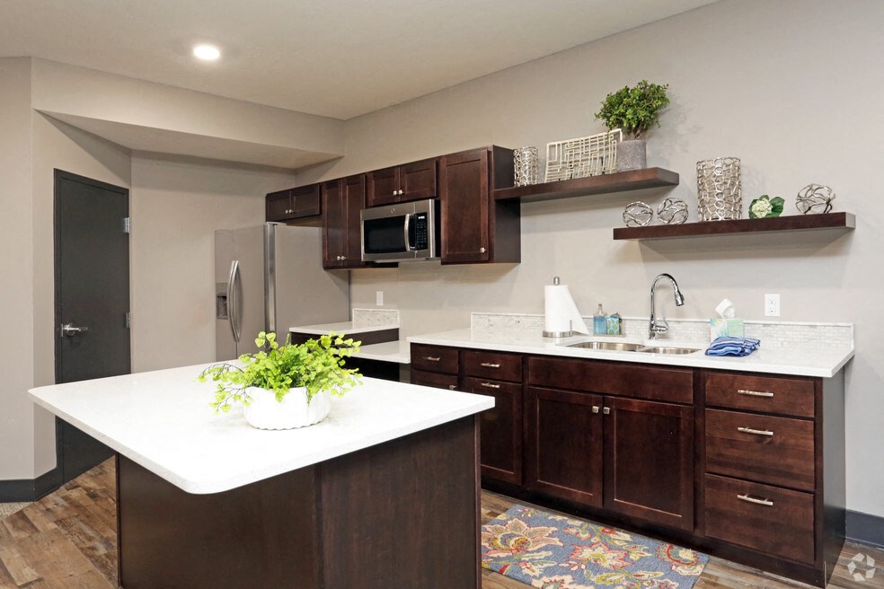 a kitchen with wooden cabinets and a white counter top
