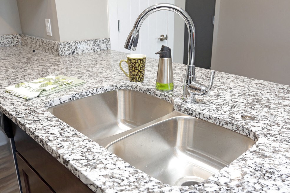 a sink in a granite counter top in a kitchen