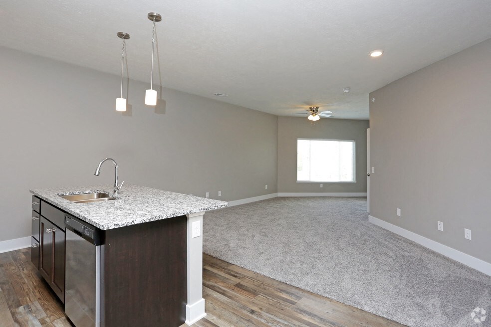 the kitchen and living room of a new home