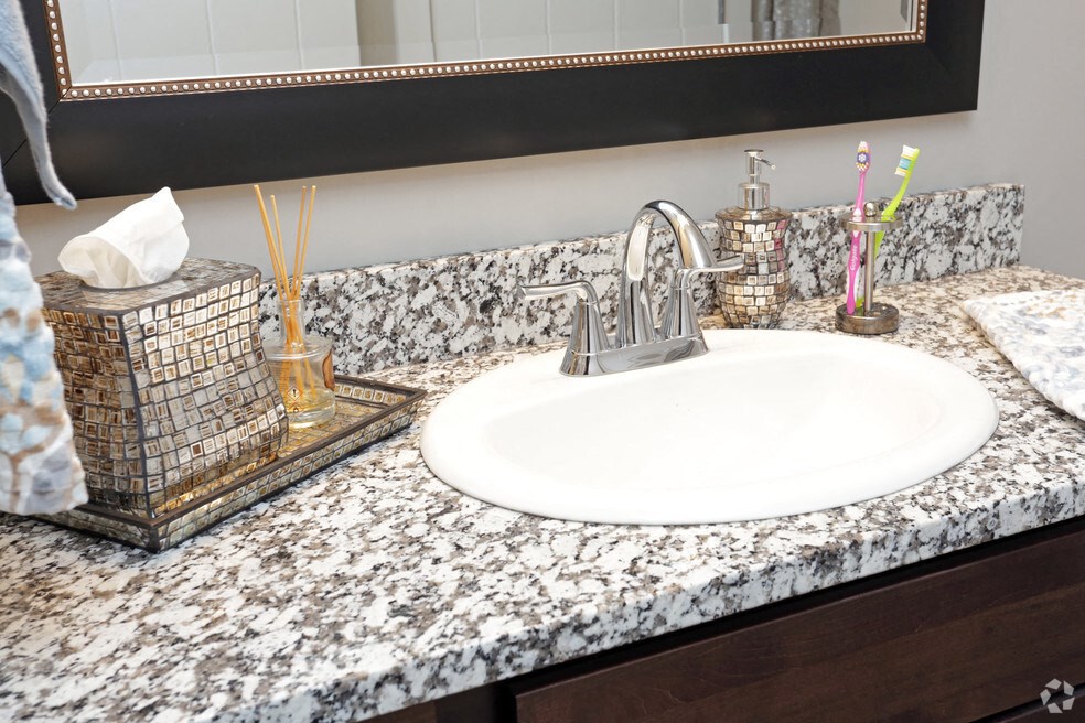 a bathroom counter with a sink and a mirror