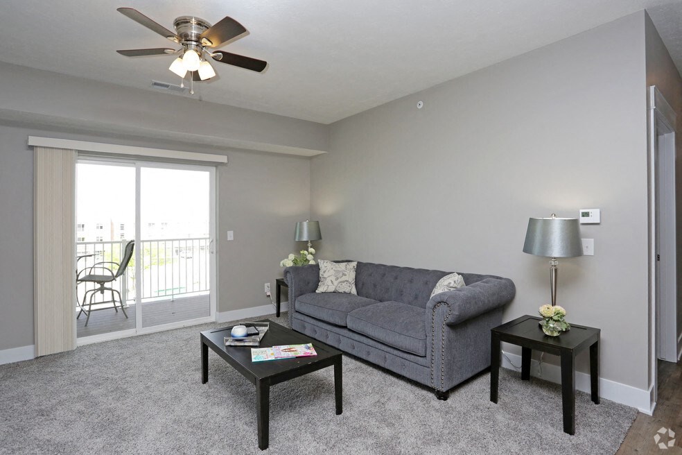 a living room with a couch and a ceiling fan
