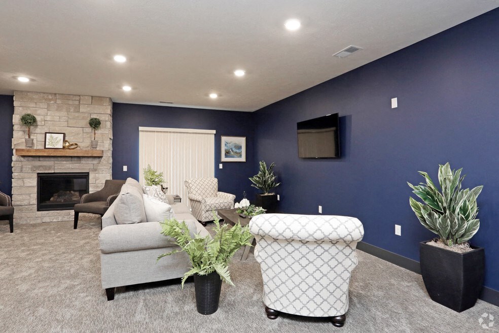 a living room with a blue accent wall and a fireplace