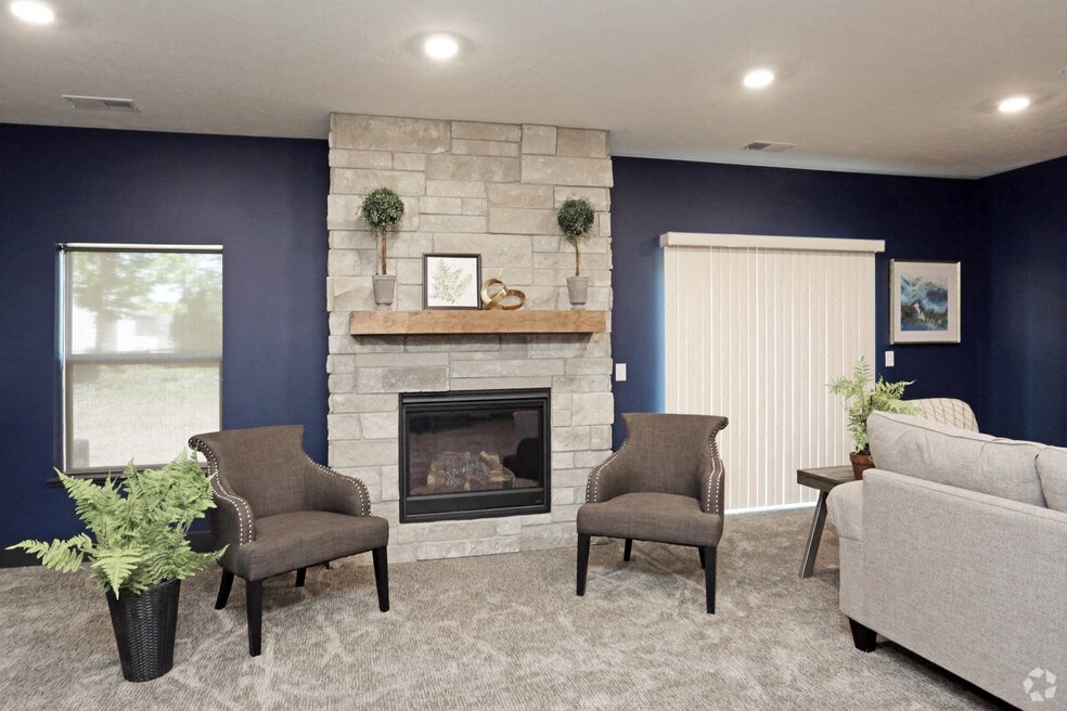 a living room with blue walls and a stone fireplace