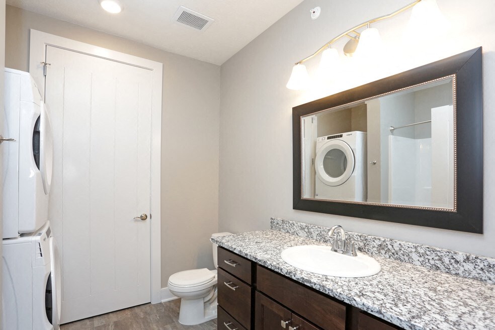 a bathroom with a sink and a toilet and a mirror