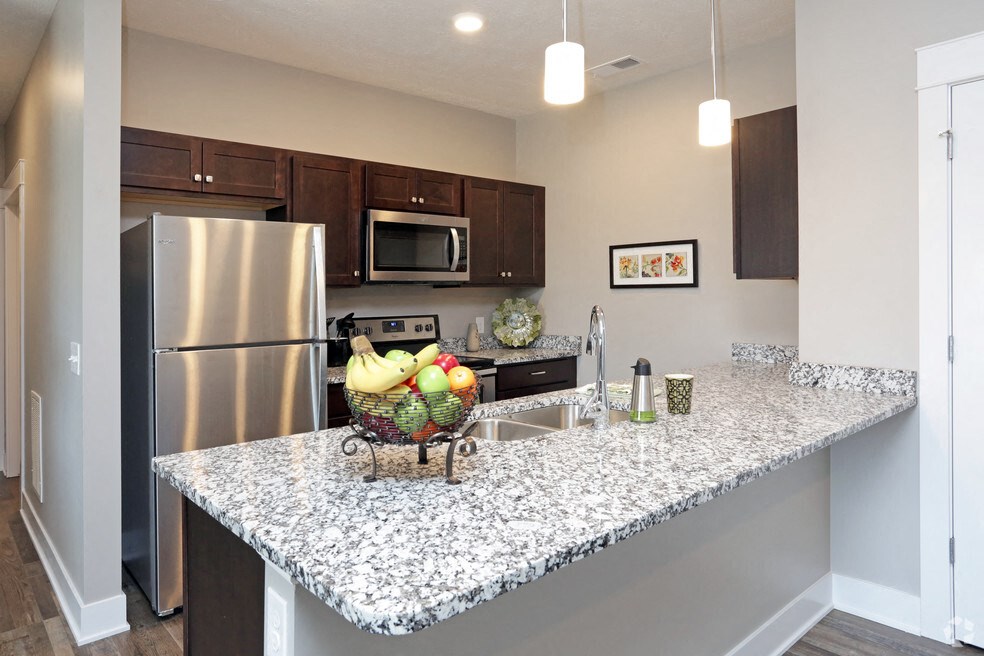 a kitchen with stainless steel appliances and a granite counter top