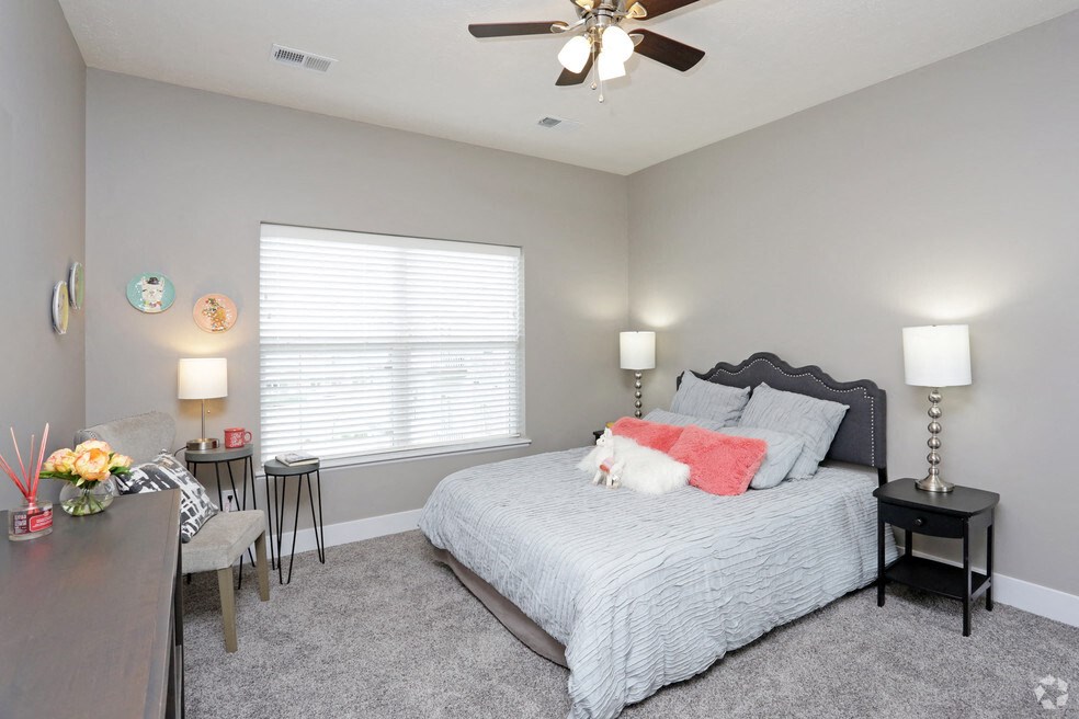 a bedroom with a bed and a ceiling fan