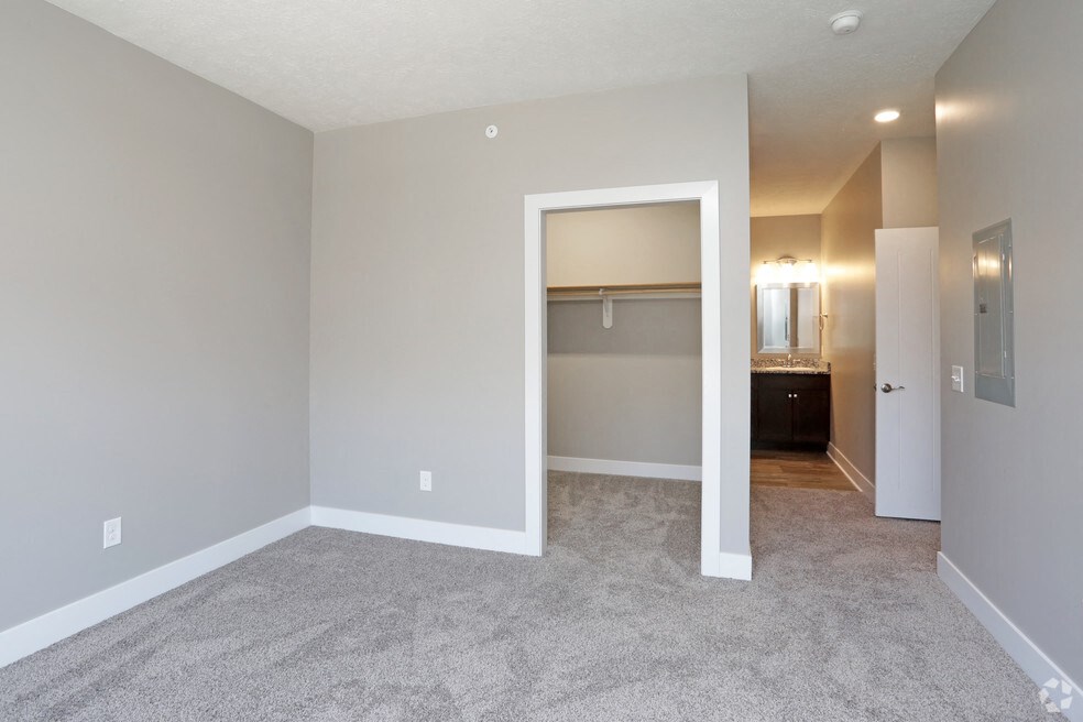 an empty bedroom with a closet and a bathroom