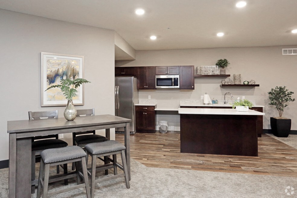 a kitchen and dining room with a table and chairs