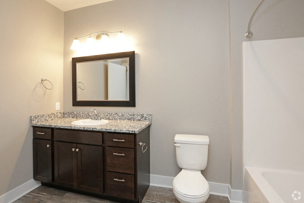 a bathroom with a sink toilet and a mirror