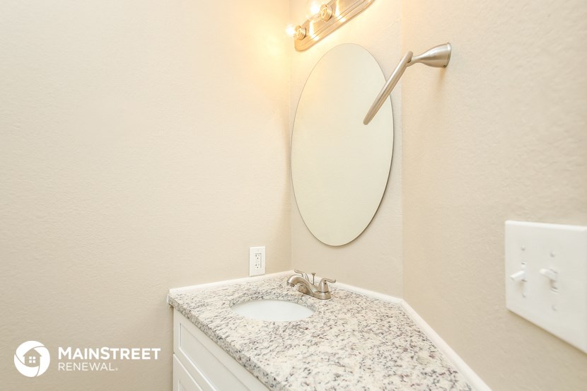 a small bathroom with a sink and a mirror and a shower
