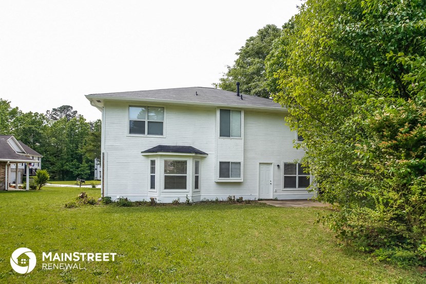 a white house with a yard in front of it