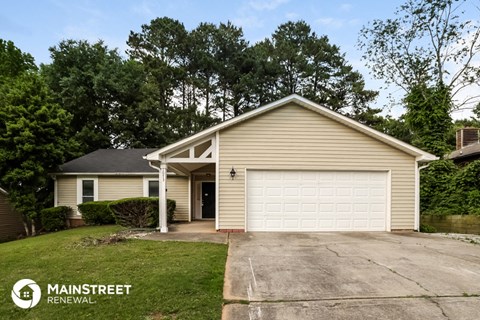 a home with a white garage door and a driveway