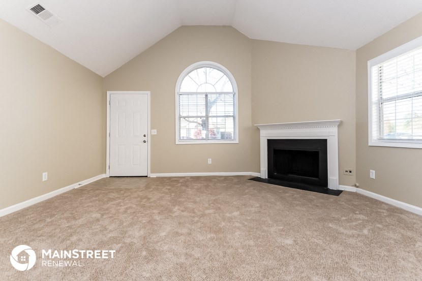 the living room of a home with a fireplace