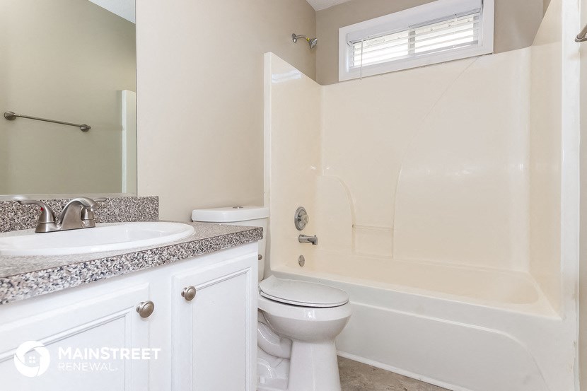 a bathroom with a sink toilet and a bath tub