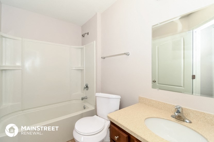 a bathroom with a sink toilet and a shower