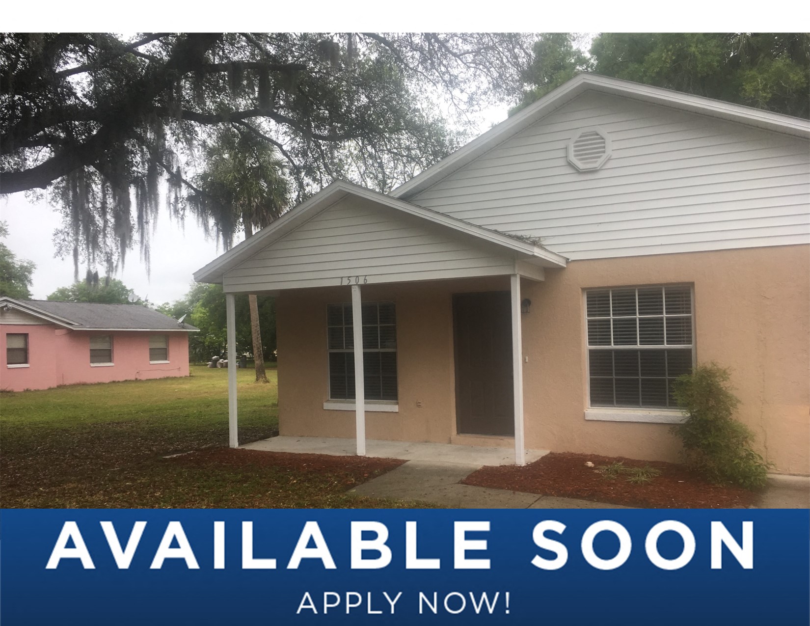 a white house with a pink house in the background