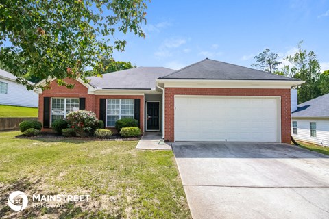 a small brick house with a white garage door