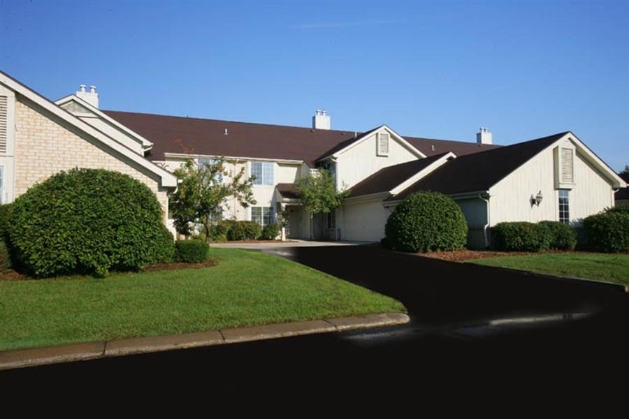 a white house with a driveway in front of it