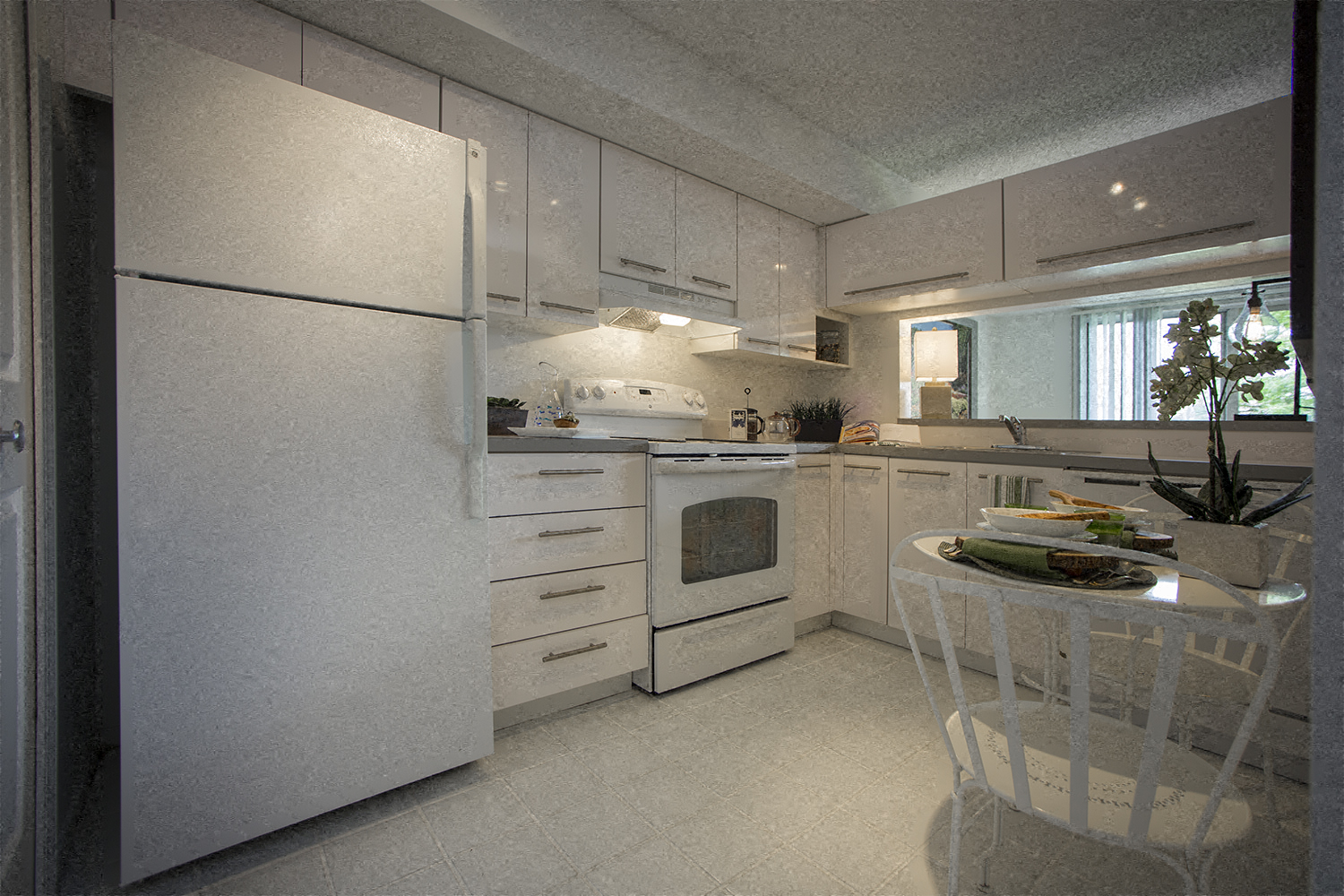 a kitchen with a white refrigerator and a table