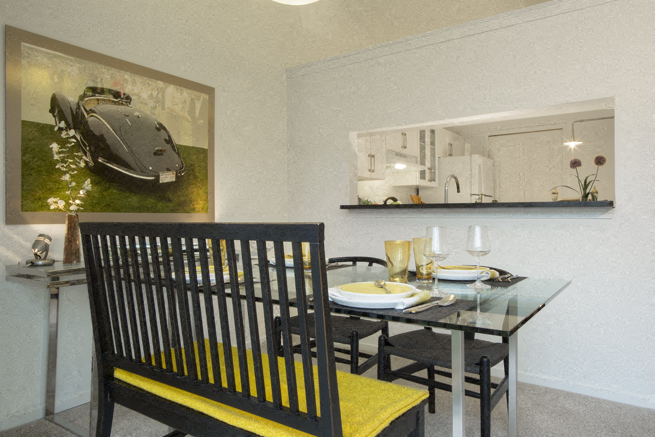 a dining room with a glass table and chairs