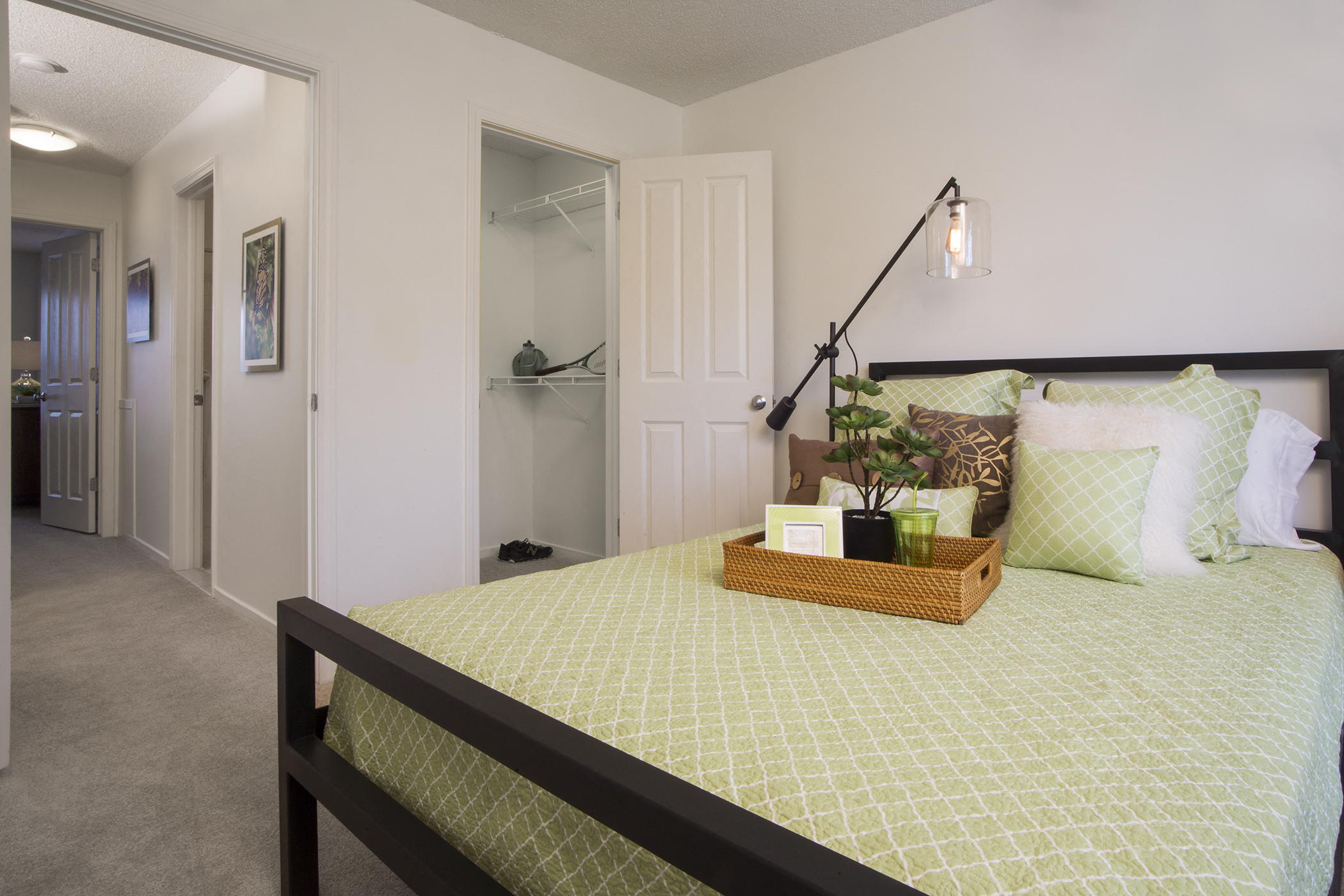 a bedroom with a bed and a closet with a mirror