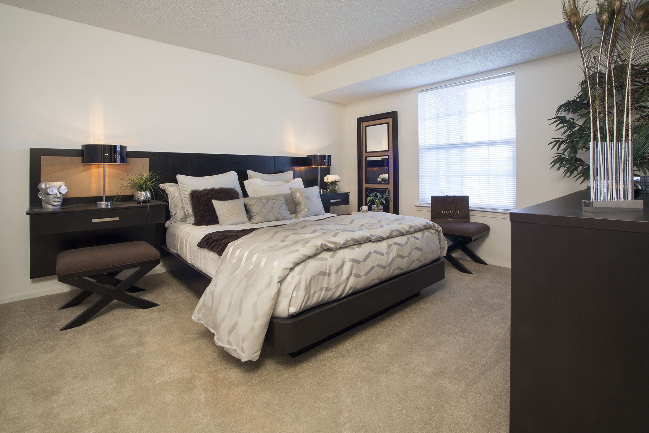 a bedroom with a bed and a dresser and a window