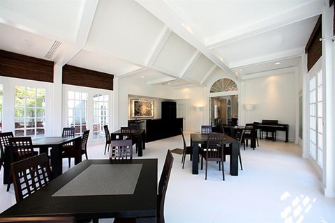 a large dining room with tables and chairs