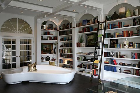 a living room with a couch and bookshelves