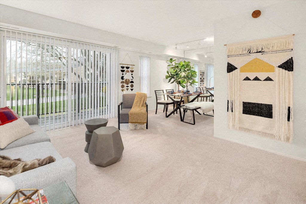 a living room with a fireplace and a table and chairs