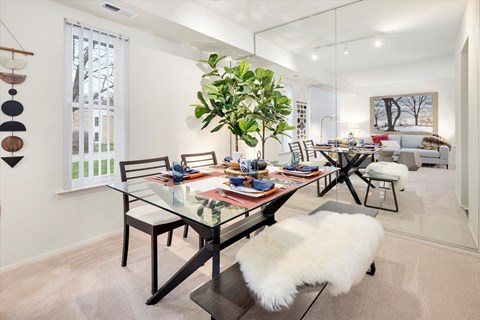 a dining room with a table and chairs