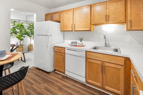 a kitchen with white appliances and wooden cabinets