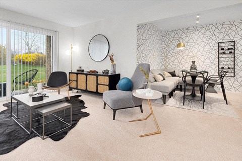 a living room and dining room with a table and chairs