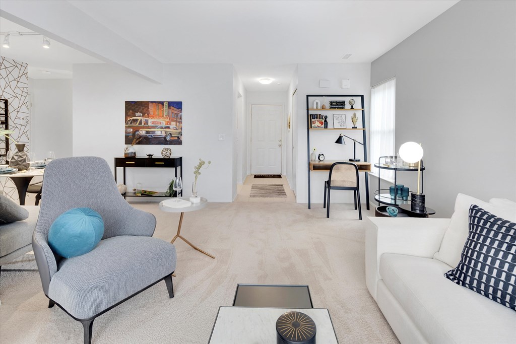 a living room with a couch and a chair and a table