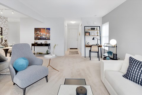 a living room with a couch and a chair and a table